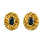 A pair of 18K yellow gold Byzantine earrings with a faceted sapphire centerpiece and intricate granulation patterns around the circumference.