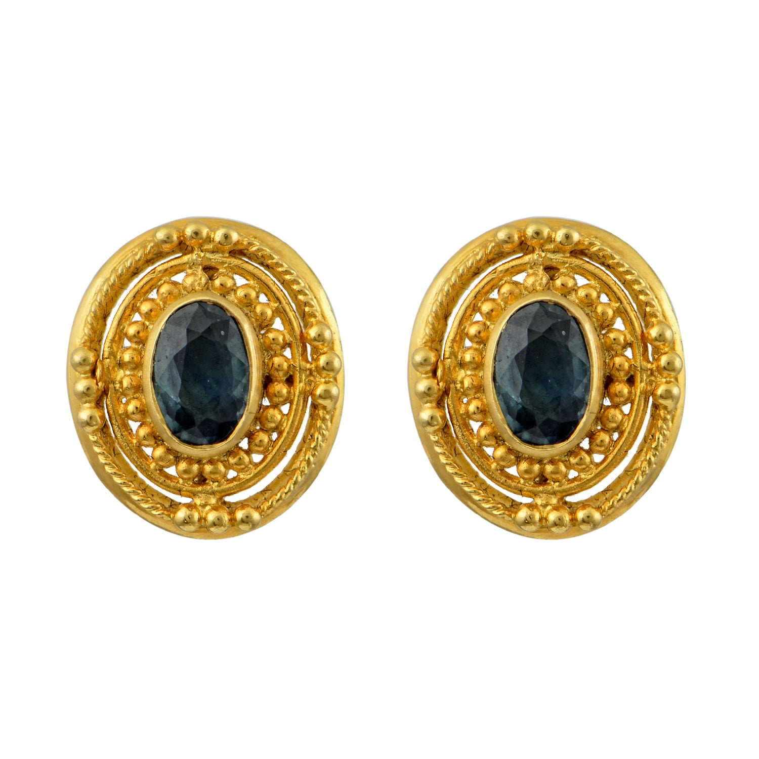 A pair of 18K yellow gold Byzantine earrings with a faceted sapphire centerpiece and intricate granulation patterns around the circumference.