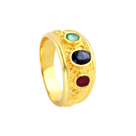 An 18K yellow gold Byzantine ring featuring three oval faceted stones in green, blue, and red, with decorative granulation and wirework.